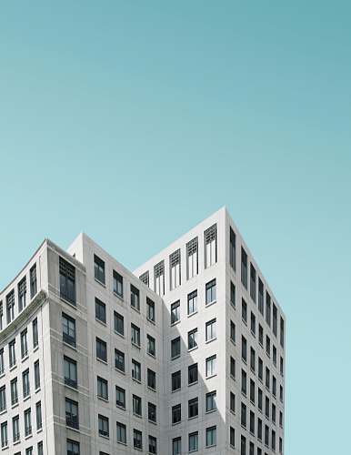 blue low angle photography of building at daytime apartment building