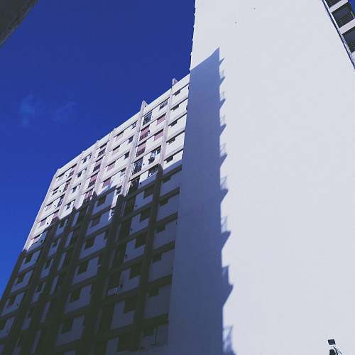 city low angle photography of high-rise building under clear sky high rise