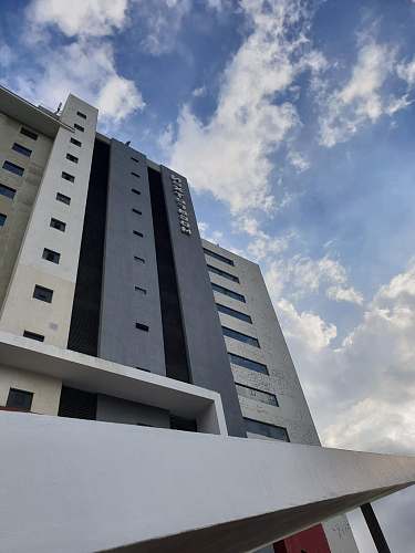 city low angle view of high rise building under cloudy day office building