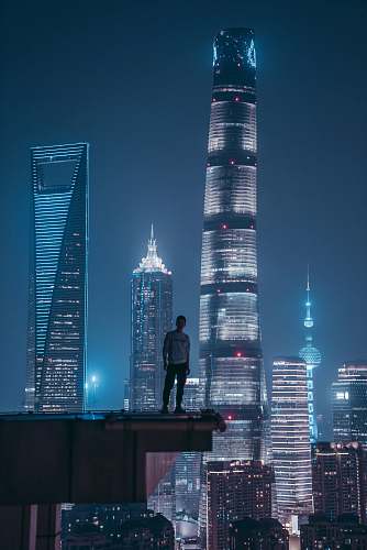 city man standing on top of skyscraper skyscraper