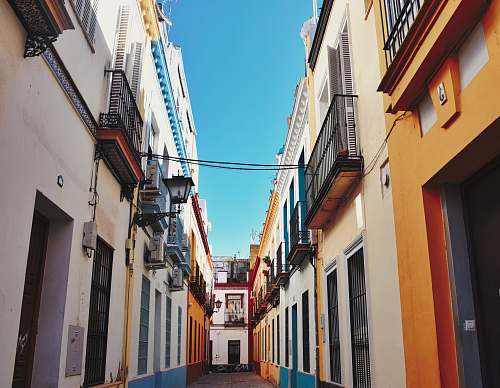 city pathway between buildings at daytime road