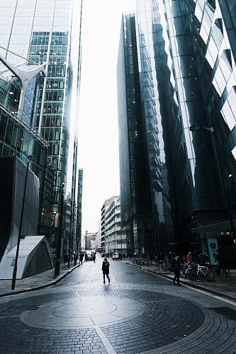 city person standing on road near building architecture