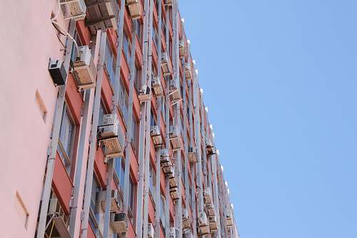 city pink and red concrete building during daytime high rise