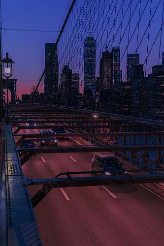 city several vehicles on bridge during night time metropolis