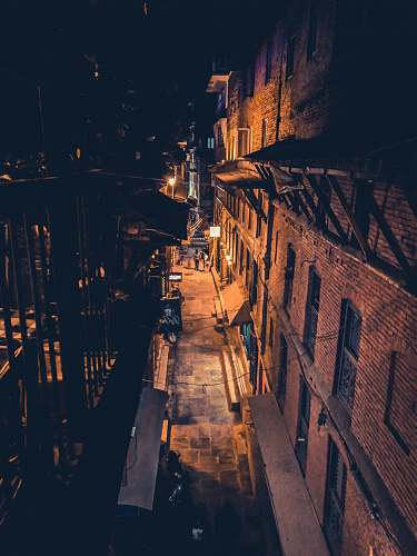 city sidewalk of a building during nighttime metropolis