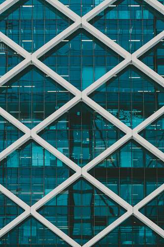 architecture teal and white high-rise building at daytime window