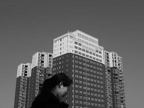 black-and-white woman standing near building office building