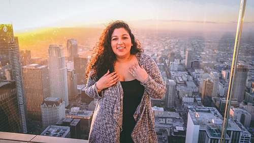 city woman standing on building rooftop high rise