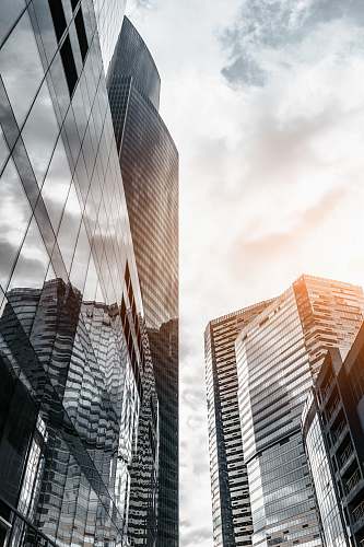 city worm view photo of city buildings under cloudy sky urban