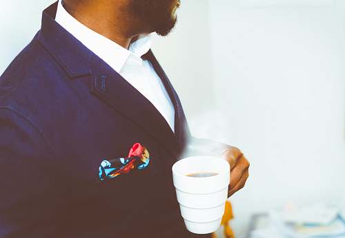 cup man holding white ceramic mug with coffee coffee