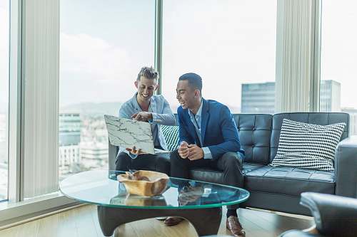 people two men in suit sitting on sofa person