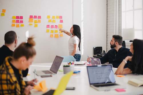 human woman placing sticky notes on wall person