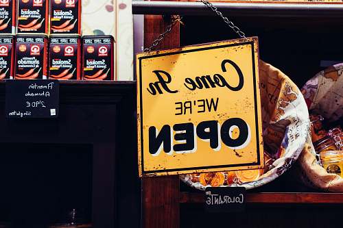 sign yellow and black come in we're open sign yellow