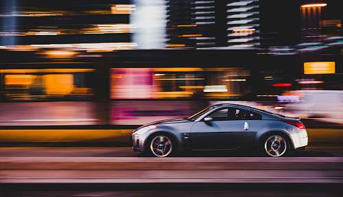speed panning photography of gray coupe on road rotterdam