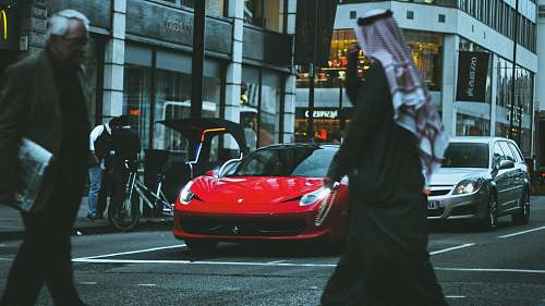 human red sports car in street people