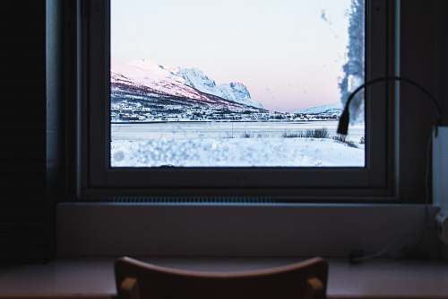 furniture closed white wooden window overlooking snow-covered mountains electronics
