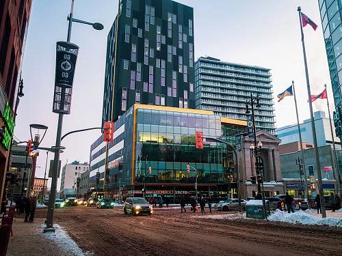 urban cars on road near building during daytime downtown