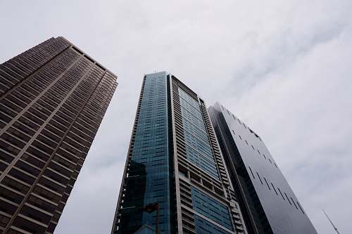 building close-up photography of three high-rise buildings during daytime office building