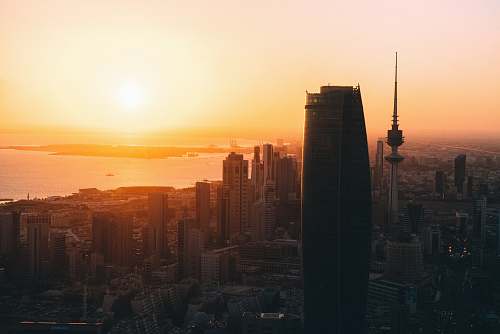 sunrise high rise buildings during sunrise sunset