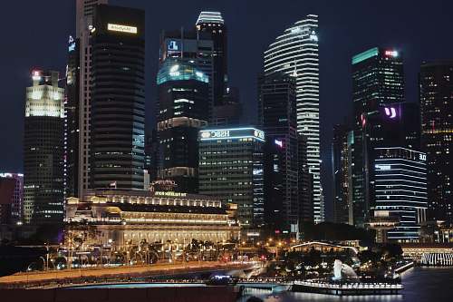 building lighted city skyline at night time town