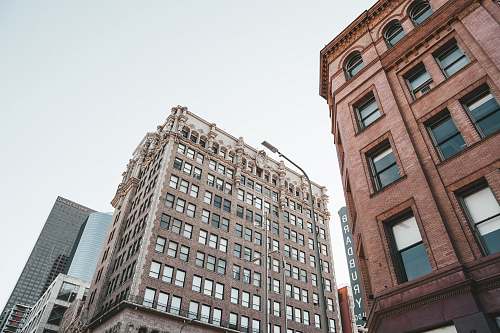 urban low angle photo of high rise tenement building town