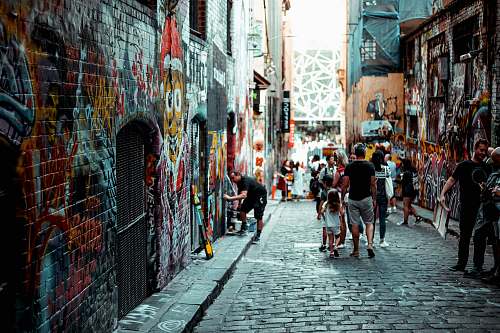 alley man and girl walking beside building alleyway
