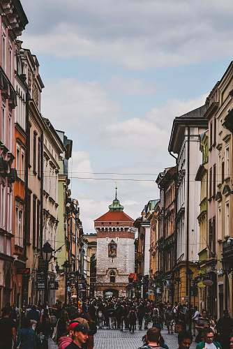 town people walking beside buildings during daytime building