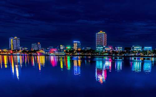 nature reflection of high rise building on water outdoors