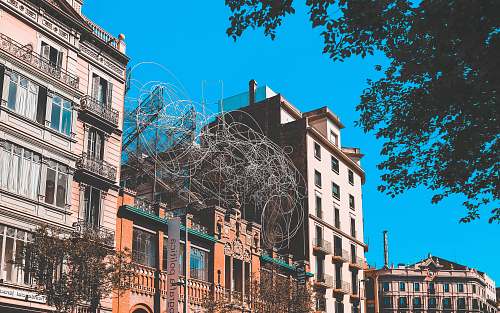 building three concrete buildings during daytime urban