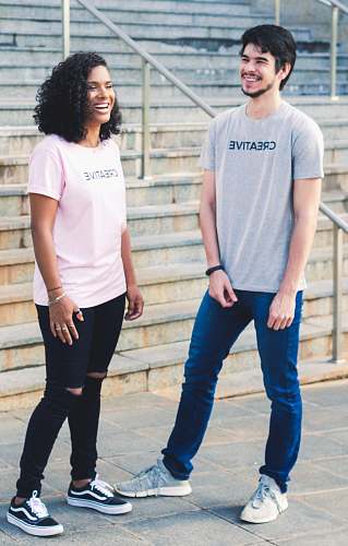 apparel man standing beside woman near concrete staircase shoe