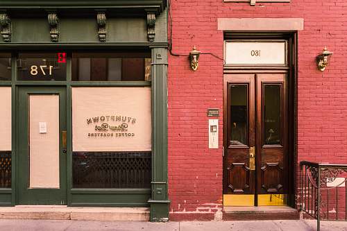 door photo of green and red concrete buildings shop
