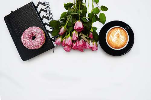 pink red rose flowers, pink dough nut graphic book and black ceramic cup kiev