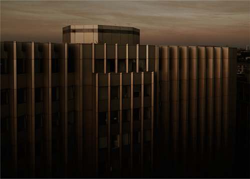 building beige concrete building under cloudy sky during sunset architecture