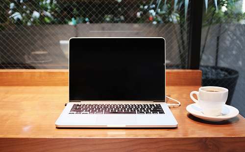 laptop laptop computer beside coffee mug cup