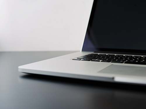laptop silver laptop computer on black table tech