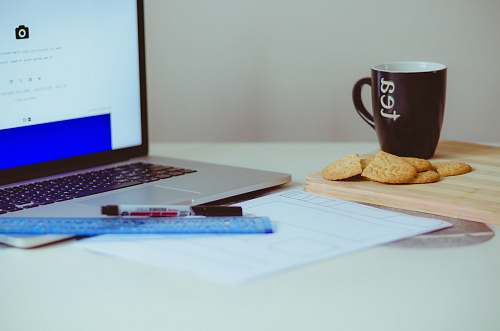 biscuit pastry beside ceramic mug cookie