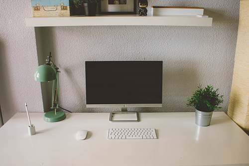 grey silver iMac with Apple Magic Keyboard and Mouse on white table valladolid