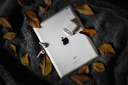 phone AirPods and charging case on iPad cell phone