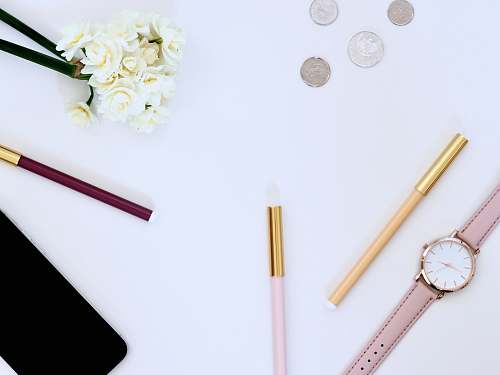 desktop flat lay photo of watch on top of table money