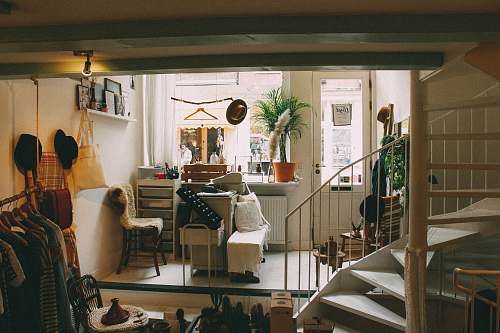 plant empty spiral staircase near white wooden door chair