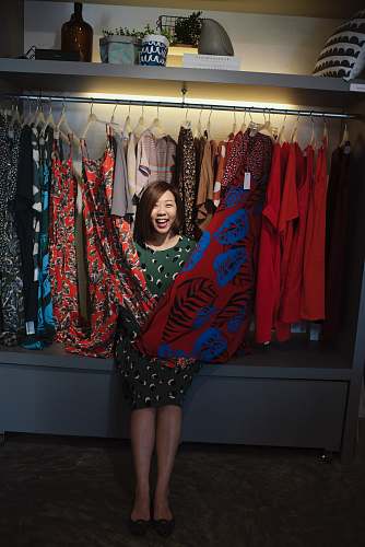 clothing smiling woman standing on different dresses lot apparel