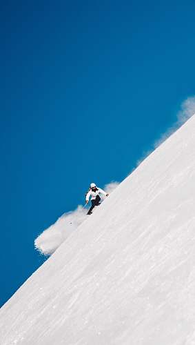 blue person snowboarding on mountain cliff norway