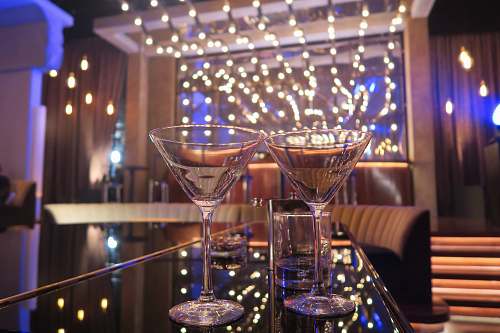 lighting two Martini glasses beverage