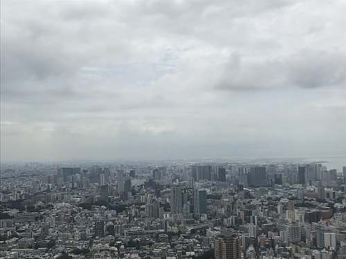 landscape city with high-rise buildings under white and gray skies during daytime nature