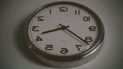 clock round silver wall clock at 3:38 tick tock