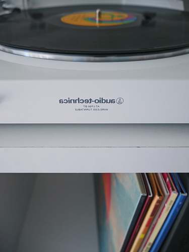 file white Audio-Technica wireless turntable near vinyl record sleeve record