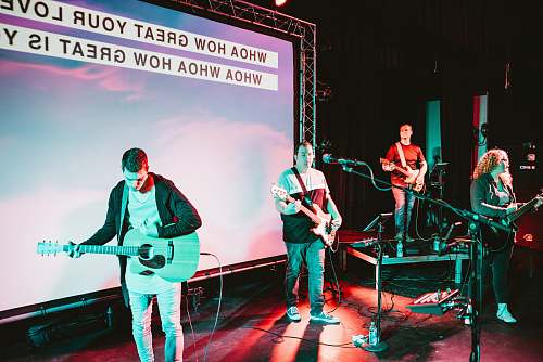 music four men band performing on stage musician