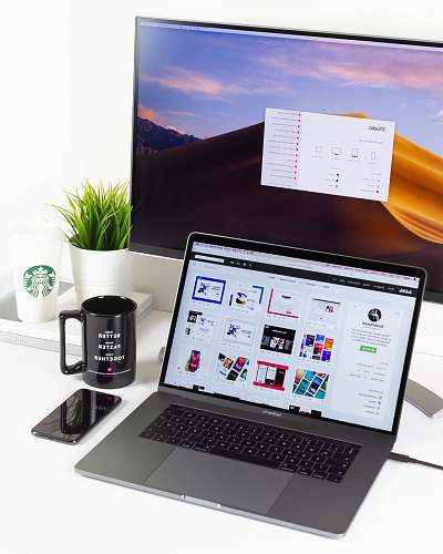 computer laptop near mug and computer monitor electronics