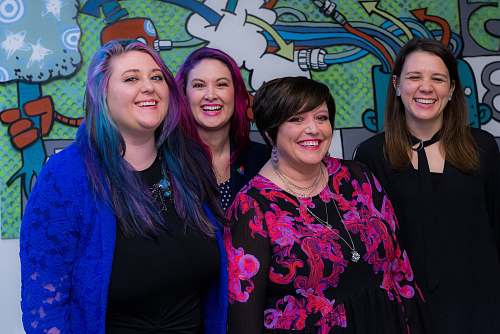 person four smiling womens standing inside room apparel