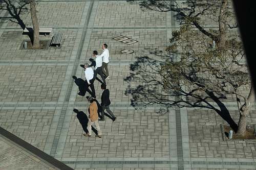 person group of men walking at park pedestrian